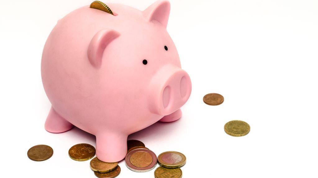 Piggy bank with coins, saving money for a holiday