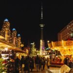 Best destinations to visit at Christmas: festive Christmas market at night with illuminated stalls