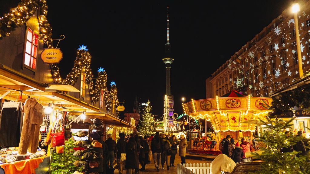 Best destinations to visit at Christmas: festive Christmas market at night with illuminated stalls