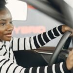 Enterprise car rental UK: smiling driver at the wheel of a hire car