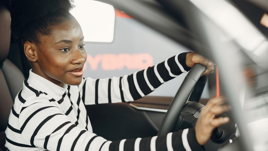 Enterprise car rental UK: smiling driver at the wheel of a hire car