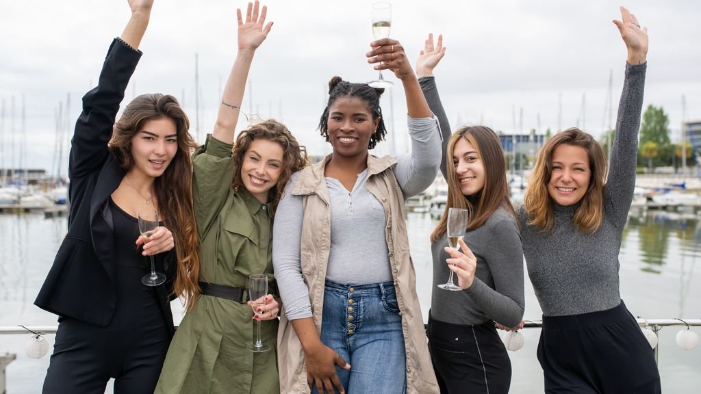 Hen do destinations: group of women celebrating with champagne outdoors