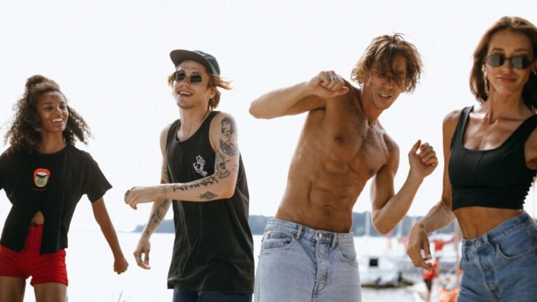Lads and girls holiday destinations: friends dancing at a beachside party